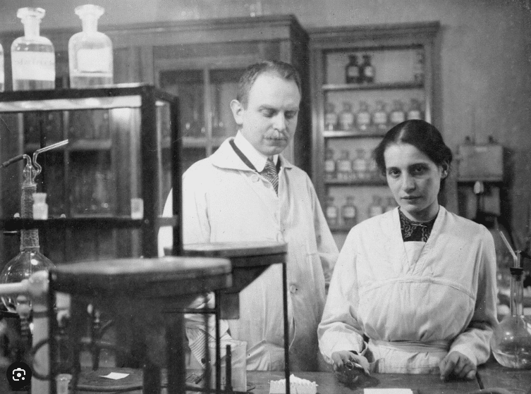 שיתוף פעולה ארוך שנים, לרוב בתנאים לא שוויוניים. אוטו האן וליזה מייטנר במעבדה בברלין, ככל הנראה ב-1912 | מקור: ויקיפדיה, נחלת הכלל