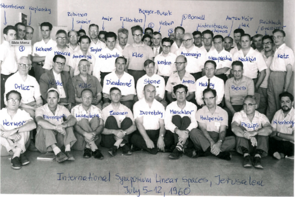 קיבל משרה באוניברסיטה העברית בזכות בריחת המוחות. אגמון (עומד שמיני מימין) בסימפוזיון בינלאומי בנושא מרחבים ליניאריים בירושלים, 1960| מתוך מאמר לכבוד אליוב ליב (Liebb)