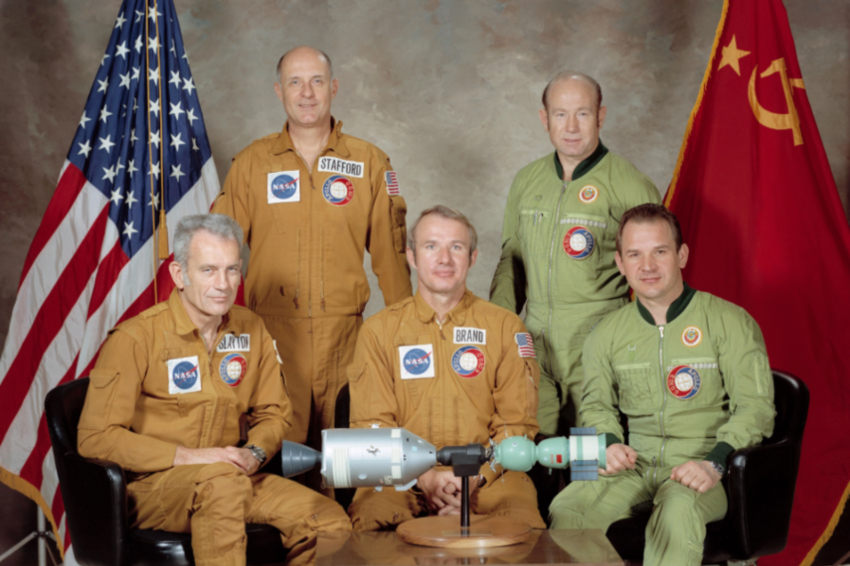 שילוב של אסטרונאוטים מנוסים וכאלה שהמתינו זמן רב לטיסת החלל הראשונה. משמאל: סלייטון, סטפורד, ברנד, לאונוס וקובסוב, עם דגם של החלליות המחוברות | צילום: NASA