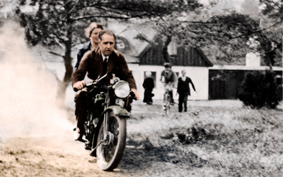 לא הבין מדוע האלקטרונים לא נופלים. בוהר ואשתו מרגריט על האופנוע של חברו, הפיזיקאי ג'ורג' גאמוב | PHOTOGRAPHER GEORGE GAMOW, COLOURED BY SCIENCE PHOTO LIBRARY FROM A MONOCHROME COURTESY OF NEILS BOHR ARCHIVE, AMERICAN INSTITUTE OF PHYSICS