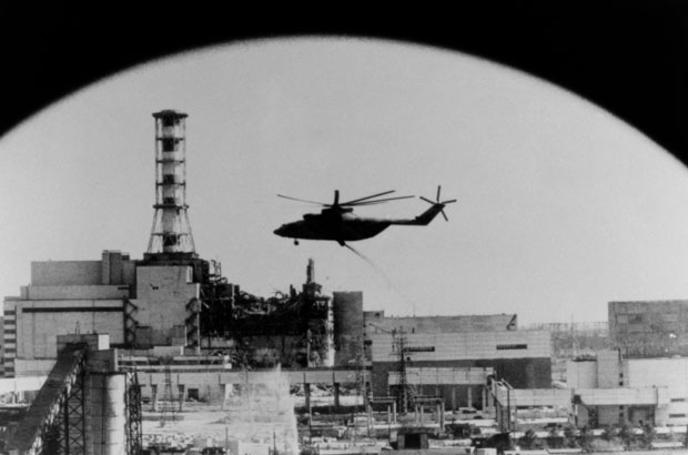 מסוק מטיל חומרים סופגי קרינה על ליבת הכור החשופה לאחר הפיצוץ | מקור: Science Photo Library