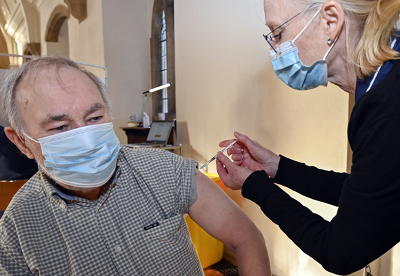 Picture of a man injected with a vaccine | Dr P. Marazzi / Science Photo Library