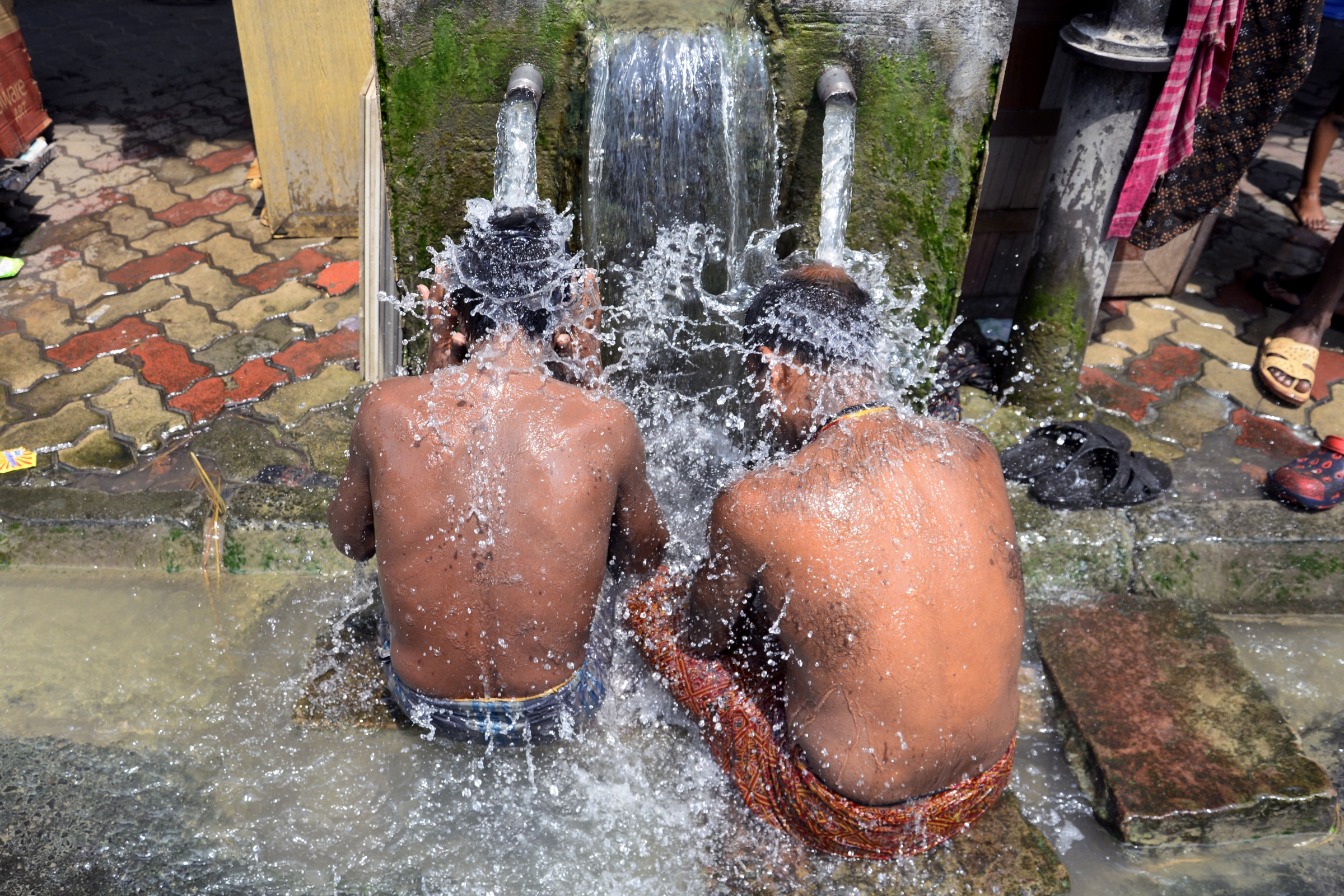 שיאי טמפרטורות של כל הזמנים. ילדים בכלכותה שבהודו מנסים לצנן עצמם בגל החום | צילום: Shutterstock